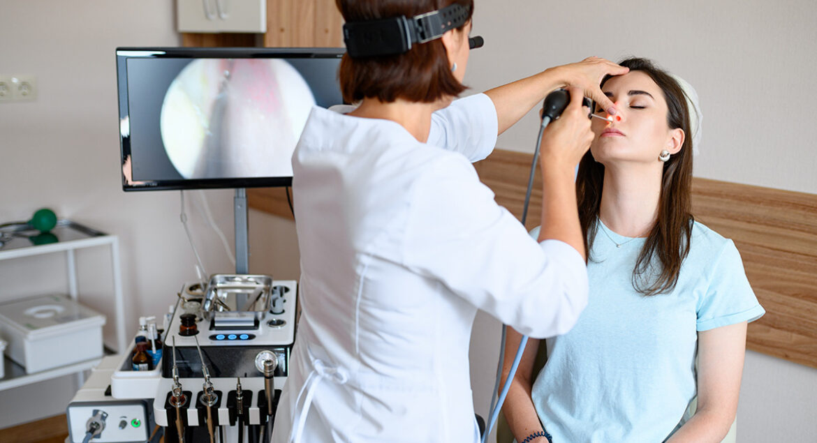 ENT doctor preparing for HAAD licensing exam with study materials