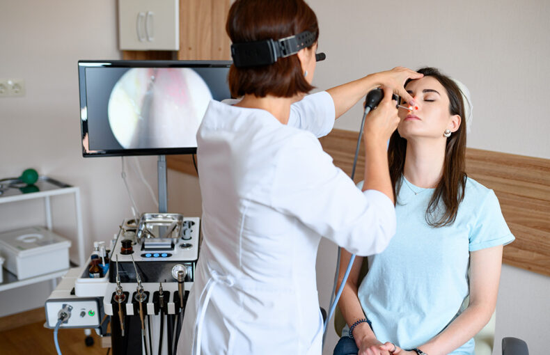 ENT doctor preparing for HAAD licensing exam with study materials